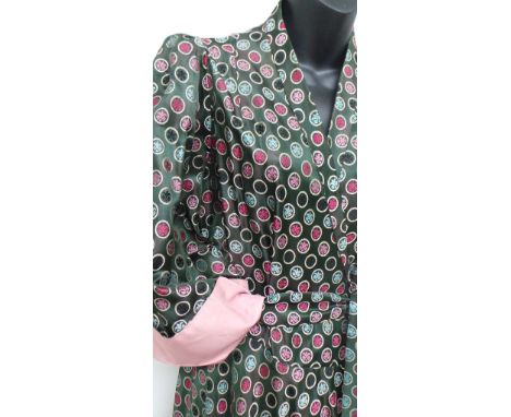 A 1940's 'Harvey Nichols' taffetta house coat green background with a pink and blue fleur du lis pattern throughout.  The thr