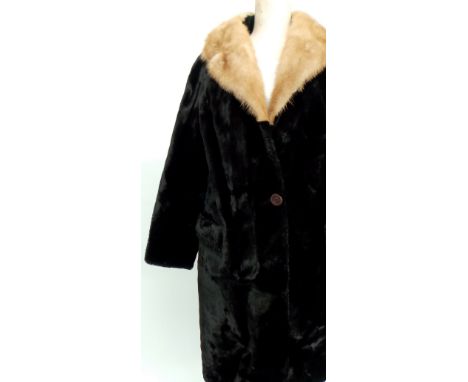 Two fur coats. A 1950's brown fur coat with shawl collar and deep turn back cuffs. Approx size 10. A 1960's black faux fur co