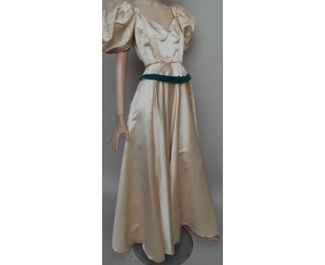 A full length cream silk ball gown circa 1940's. Very wide neck and full puff sleeves, the skirt is full circle. The green ve