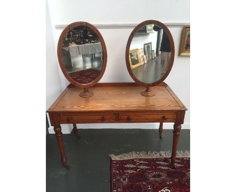 A Victorian stripped pine dressing table / coiffeur makers table, the rectangular top cross banded with ebony with two oval m