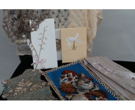 A mixed lot of vintage textiles to include lace and trimmings, a beadwork panel and a boned beaded waist sash (damaged).  A f