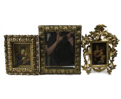 Two Madonna and child studies in gilt wood frames,  together with a metalwork mirror with bevelled glass, one study is a prin