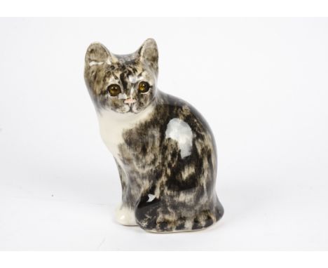 A Winstanley ceramic tabby cat, with orange glass eyes, painted signature to the underside, height 22 cm 