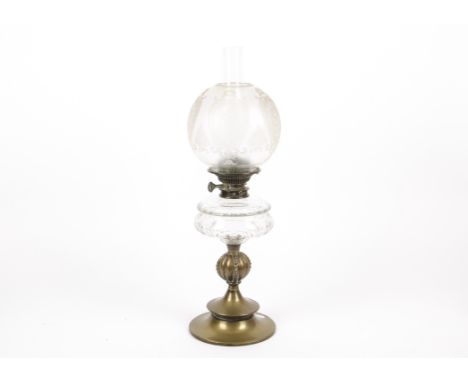 A Victorian oil lamp, having an etched opalescent glass shade above a clear glass font, supported on a brass pedestal, height