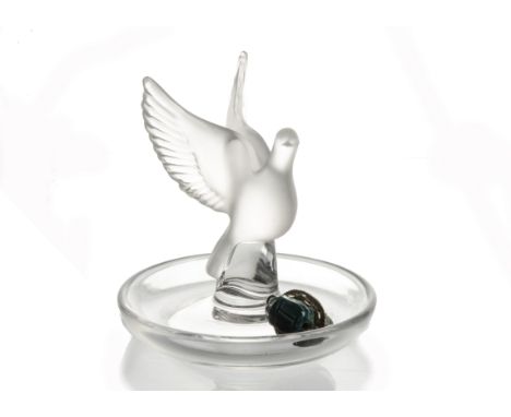 A Lalique opaque glass dove on a circular dish, the underside etched 'Lalique France', height 10 cm, diameter 10 cm, together
