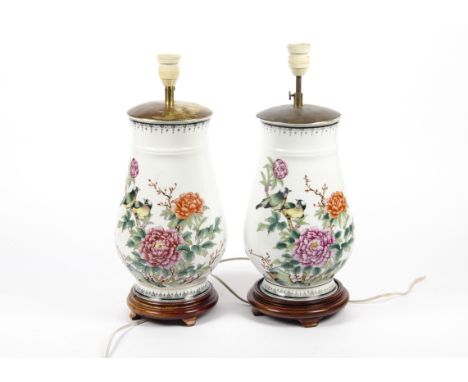 A pair of 20th Century oriental vases converted into lamp bases, the ceramic ovoid shaped body painted with birds and flowers
