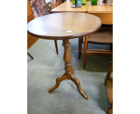 Ercol Circular wine table on turned supports above tripod base 