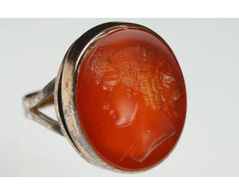 Carnelian intaglio gilt metal ring, the oval carnelian intaglio depicting Roman head facing left, dimensions approx 21.5 x 18