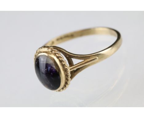 Blue John 9ct yellow gold ring, the oval cabochon cut Blue John measuring approx 8 x 6mm, rubover set, rope twist surround, t