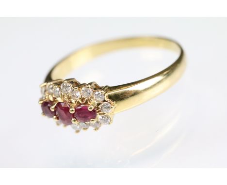 Ruby and diamond 18ct yellow gold cluster ring, three rubies, the central round mixed cut ruby diameter approx 3.5mm, shared 