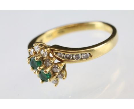 Emerald and diamond 18ct yellow gold flower head cluster ring, two small round mixed cut emeralds, ten small round brilliant 