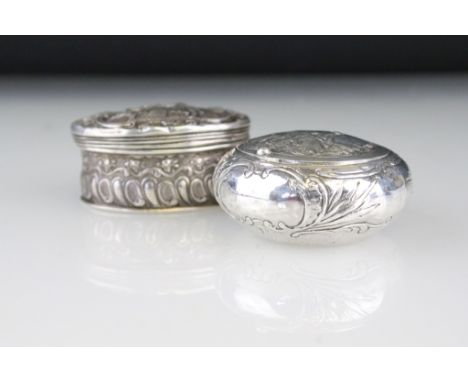 Late 19th century silver circular snuff box, repoussé idyllic courting couple scene to the hinged lid, foliate decoration to 