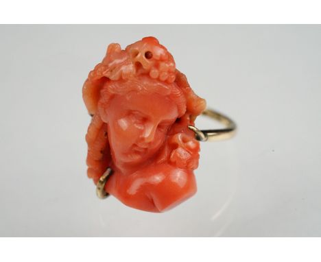 19th century coral 9ct yellow gold ring, the carved coral depicting a female head with grapes and vine leaves in her hair, di