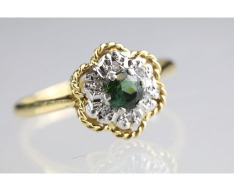 Tourmaline and diamond 18ct yellow gold and white gold set flower head cluster ring, the round mixed cut green tourmaline to 