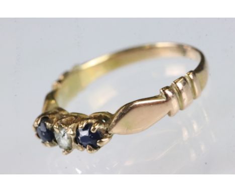 Sapphire and diamond yellow metal three stone ring, small rose cut diamond to the centre, two small round mixed cut blue sapp