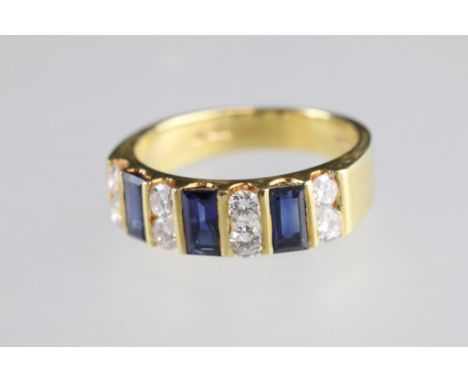 Sapphire and diamond 18ct yellow gold ring, three baguette cut blue sapphire, dimensions approx 5 x 2.5mm, eight round brilli