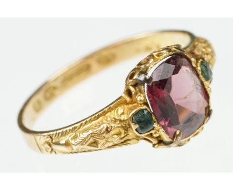 Victorian garnet and emerald 15ct yellow gold ring, the oval mixed cut garnet measuring approx 7x 6mm, rubover claw set, two 