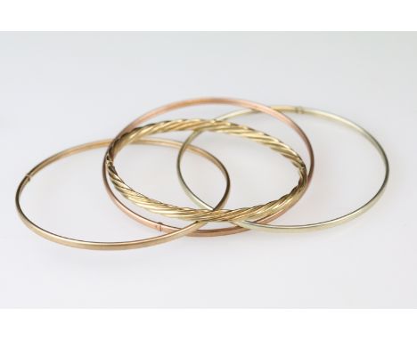 9ct yellow gold writhen twist hinged bangle together with a rose, yellow and white metal bangle (2)