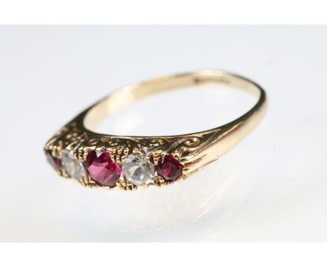 Ruby and paste 9ct yellow gold five stone ring, scroll mount, ring size Q 