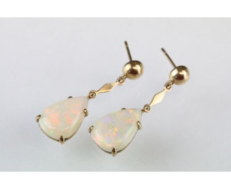 Pair of opal 9ct yellow gold drop earrings, the pear shaped cabochon cut precious white opals displaying violet, indigo, gree