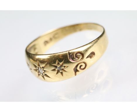 Diamond 18ct yellow gold ring, three small rose cut diamonds, gypsy settings, engraved scroll decoration to the shoulders, ri