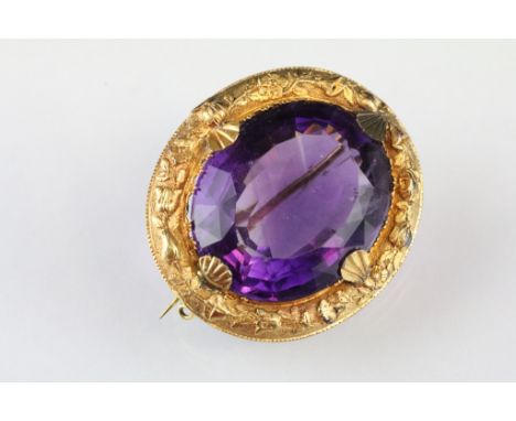 19th century amethyst yellow metal brooch, the oval mixed cut amethyst measuring approx 32 x 26 x 16mm, claw set, the claws m