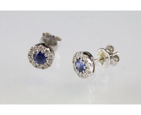 Pair of sapphire and diamond 18ct white gold cluster stud earrings, the round mixed cut sapphire to centre diameter approx 4m