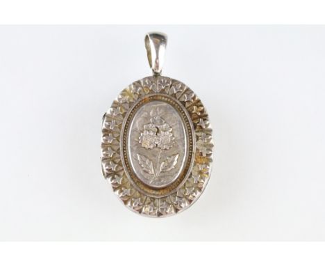 Victorian silver locket pendant, the raised oval centre with cast flower decoration, stylised surround, makers Williams &amp;