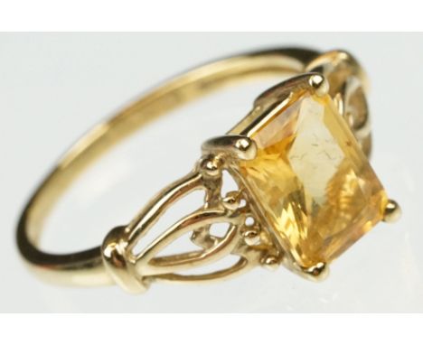 Citrine 9ct yellow gold ring, the rectangular mixed cut citrine measuring approx 8 x 6mm, claw set, pierced entwined shoulder