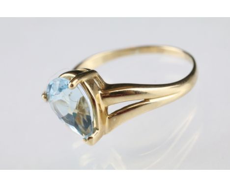 Blue topaz and diamond yellow metal cluster ring, the pear shaped mixed cut blue topaz measuring approx 9 x 7mm, claw set, fo