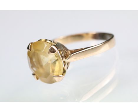 Citrine yellow metal ring, round mixed cut citrine, diameter approx 11.5mm, claw set, tapered shoulders, ring size O 