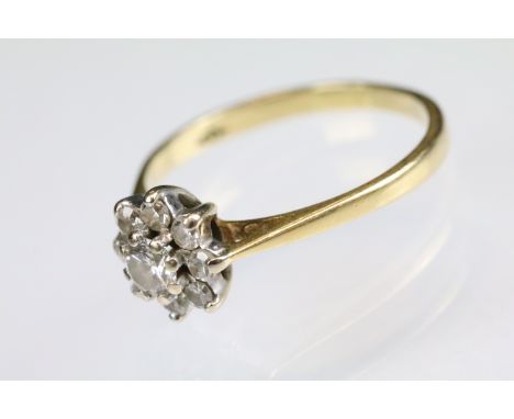 18ct gold and diamond cluster ring. The ring having a round brilliant cut diamond to the centre surrounded by eight smaller d