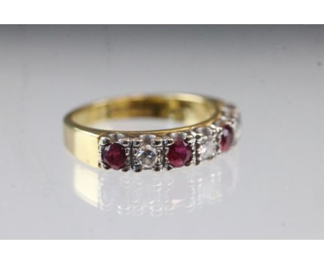 Ruby and diamond 18ct yellow and white gold set ring, four round mixed cut rubies, three round brilliant cut diamonds, total 