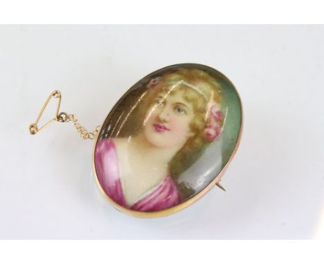 Hand painted portrait miniature yellow metal brooch, the portrait depicting female head, rubover set, applied 9ct pad, signed