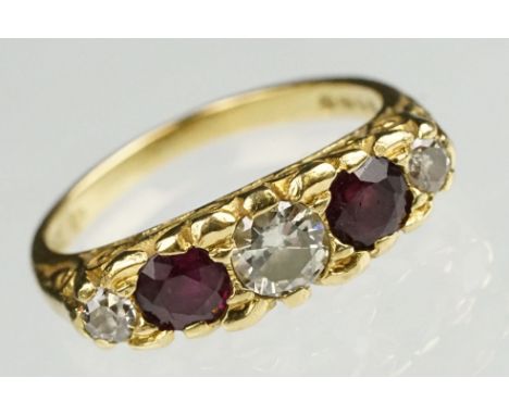 18ct gold diamond and garnet five stone ring. The ring being set with three brilliant cut diamonds and two round cut garnets 