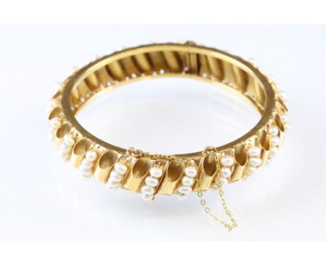 Freshwater pearl Arabic yellow gold hinged bangle, twenty-two rows of four small freshwater pearls, cylinder spacers, pin and