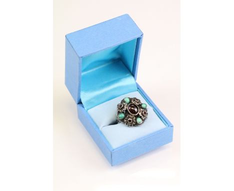 Zoltan White &amp; Co garnet and turquoise silver cluster ring, the principal oval cabochon cut garnet to centre measuring ap