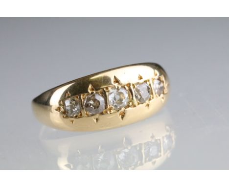 Early 20th century diamond 18ct yellow gold diamond ring, five graduated round old brilliant cut diamonds, the central princi