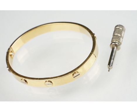 18ct yellow and white gold hinged band, screw head decoration, the fastening modelled as a screw, width of bracelet approx 6.