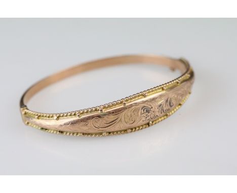 Early 20th Century Edwardian 9ct gold bangle bracelet having an engraved scrolled design to the top with beaded detail. Hallm