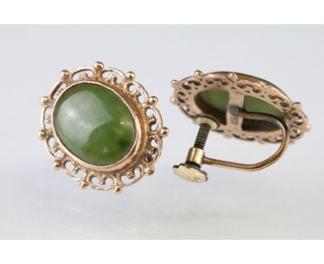 Pair of jade 9ct yellow gold earrings, the oval cabochon cut jade panel measuring approx 13.5 x 10mm, rubover set, pierced su