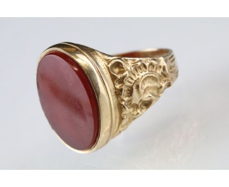 Carnelian 9ct yellow gold signet ring, the oval plain polished carnelian panel measuring approx 19 x 14mm, rubover set, cast 