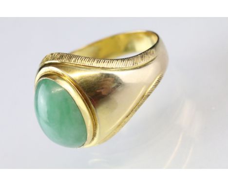 Jade 9ct yellow gold ring, the oval cabochon cut jade measuring approx 14 x 10mm, rubover set, tapered shoulders, ring size T