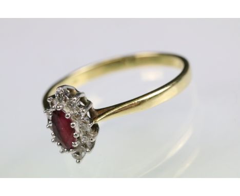 Ruby and diamond 18ct yellow gold cluster ring, the marquise ruby measuring approx 6 x 3mm, twelve small round brilliant cut 