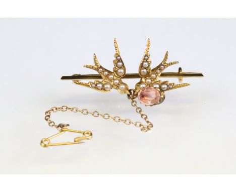 Early 20th century seed pearl yellow metal brooch, modelled as two swallows, foiled rock crystal dropper to centre, claw set,