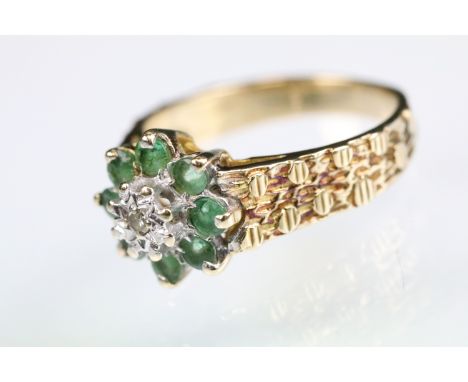 Emerald and diamond 9ct yellow gold flower head cluster ring, small round eight cut diamond to the centre, illusion set, smal