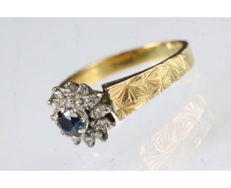 Sapphire and diamond 18ct yellow gold flower head ring, round mixed cut blue sapphire, diameter approx 4.5mm, small round eig