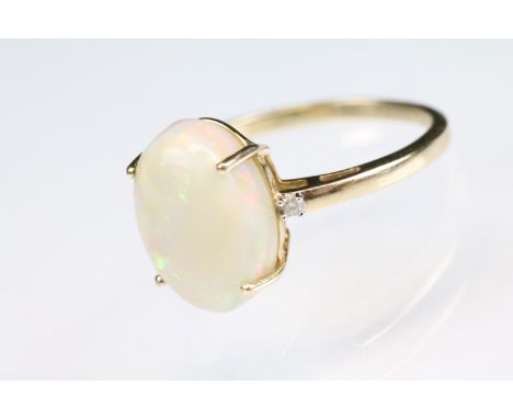 Opal 14ct yellow gold ring, the oval cabochon cut precious white opal measuring approx 14 x 10mm, displaying violet, indigo, 