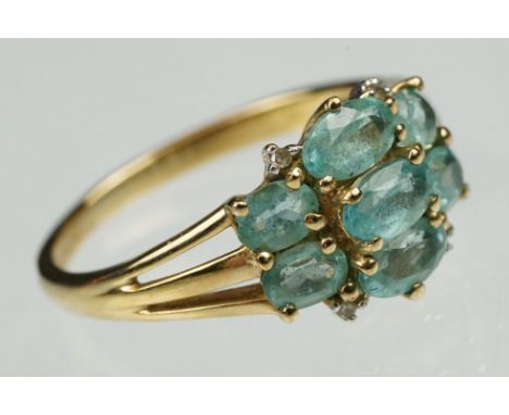 Blue stone 9ct yellow gold ring, seven oval mixed cut gemstones, claw settings, dimensions of head approx 10 x 12mm, tapered 