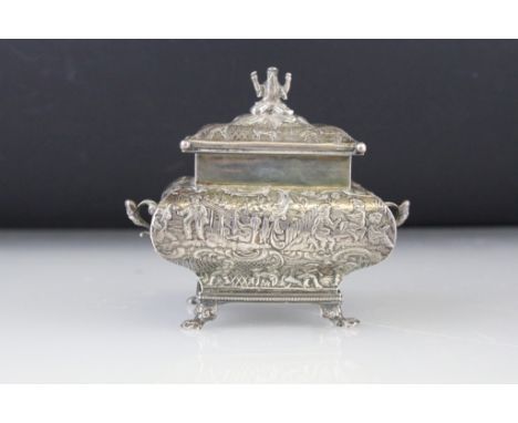 Dutch silver tea caddy, pagoda form, raised on four paw feet, twin scroll handles, the lid with cast finial modelled as a bea